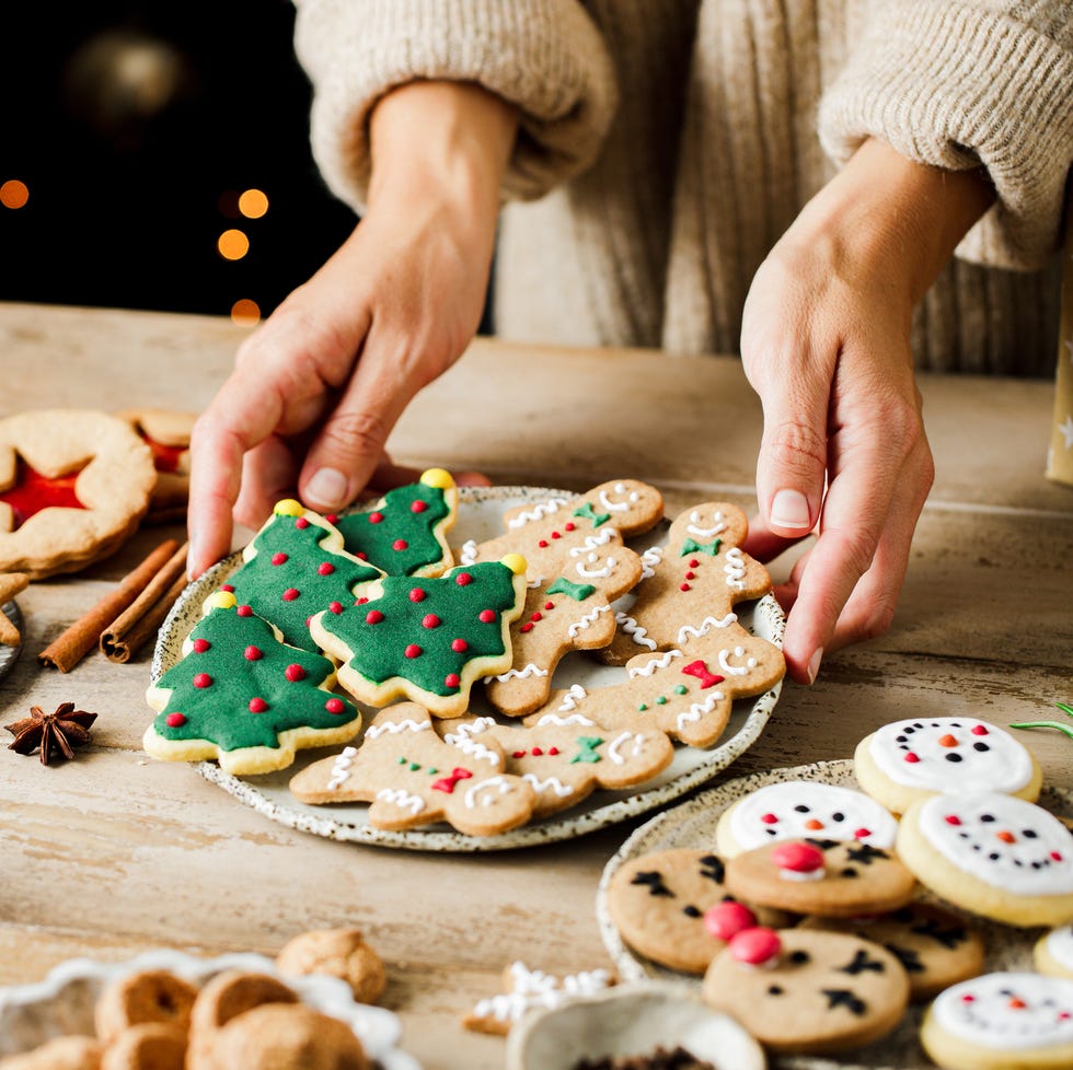 woman hands arranging sweets on christmas table