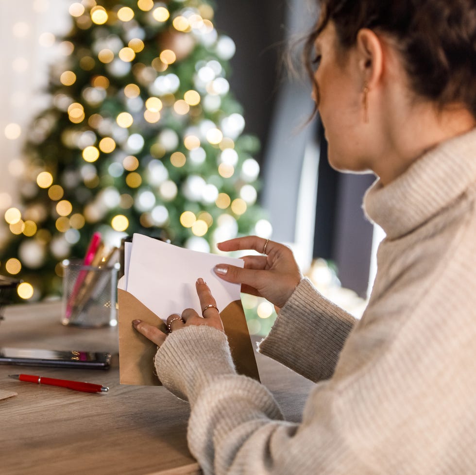 young-woman-putting-the-christmas-letter-she-wrote-royalty-free-image-1732568758