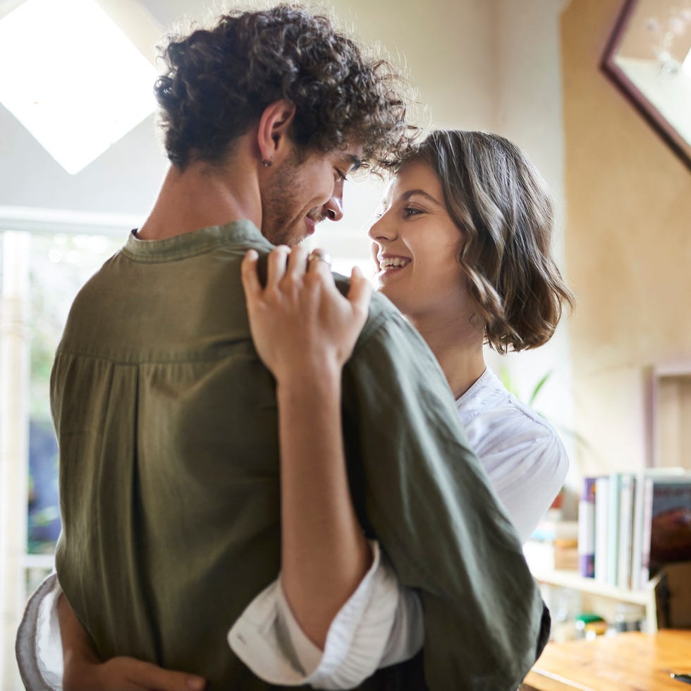 affectionate couple standing in the kitchen at home